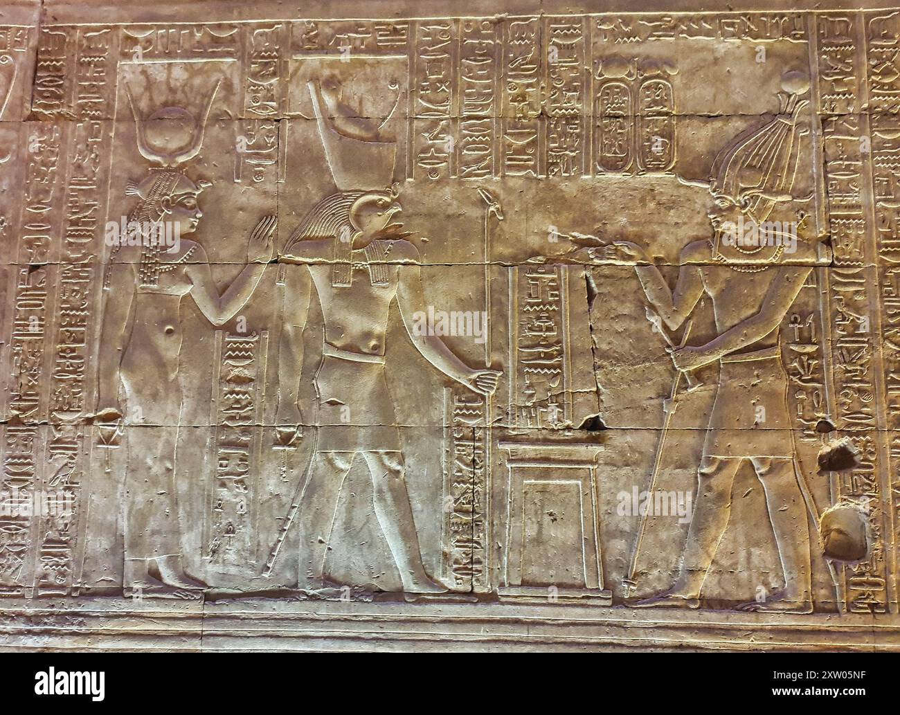 Bas relief of Ptolemy IV Philopator facing Horus and Hathor and making ...