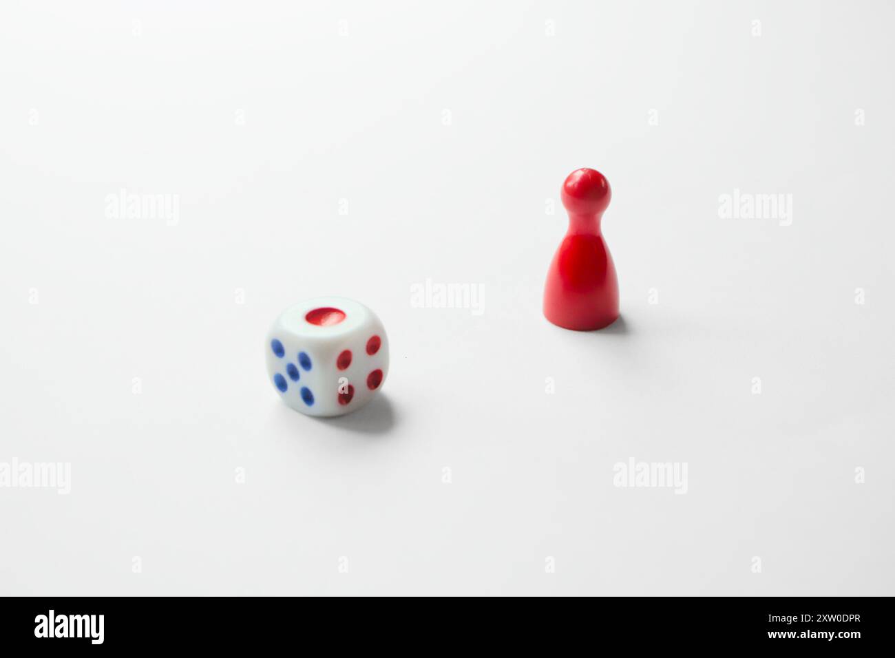 Board game piece and dice Stock Photo - Alamy
