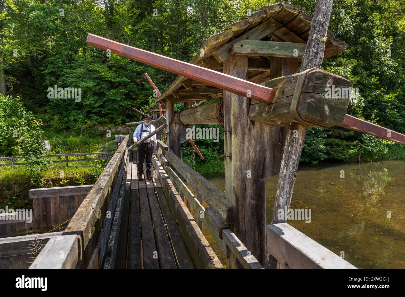 Raftsman Martin Spang from the Upper Nagold Valley Raftsmen's Guild at the Monhardter Wasserstube. It served as a dam to assist the raftsmen in floating timber. Streams were dammed to provide enough water to transport large quantities of timber from the Black Forest to distant areas on rafts. This mechanism was a central component of rafting, which was an important industry in the Black Forest for almost 500 years. Raftsman Martin Spreng. Altensteig, Baden-Württemberg, Germany Stock Photo