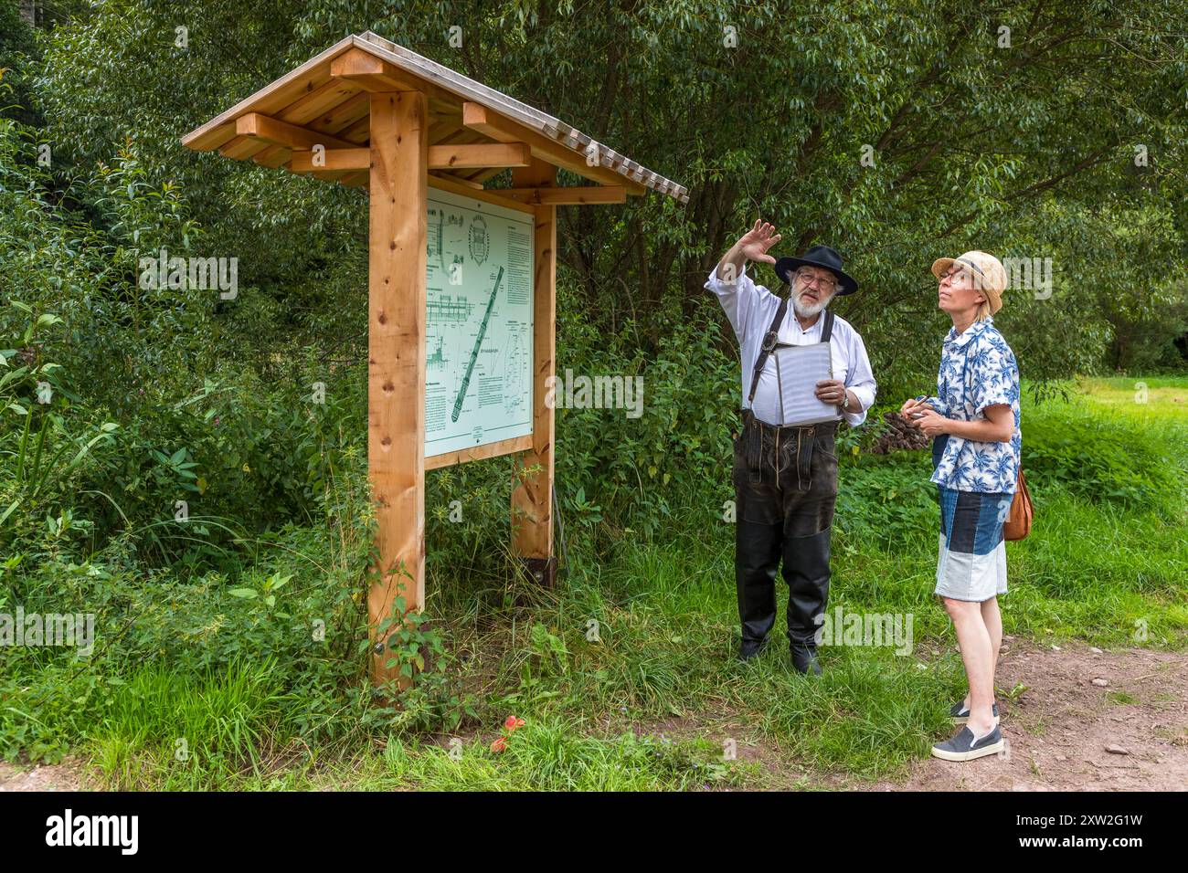 Raftsman Martin Spreng explains on a display board how a typical Nagold raft was constructed. Altensteig, Baden-Württemberg, Germany Stock Photo