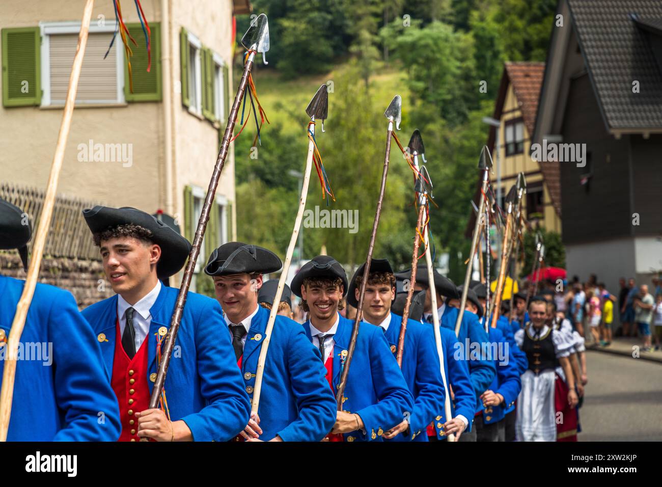 Group of shepherds with traditional shepherd's shovels on 300 years of the shepherd's run in Wildberg. The small shovel at the lower end of the shepherd's crook fulfils several practical tasks in the everyday life of a shepherd: guiding the flock, signalling for the herding dog, taking dung samples, removing plants, cutting out poisonous or troublesome plants. The shovels also have a so-called by-catch hook, which the shepherd can use to catch the sheep by the legs. Parade at the Schäferlauf 2024 in Wildberg, Baden-Württemberg, Germany Stock Photo