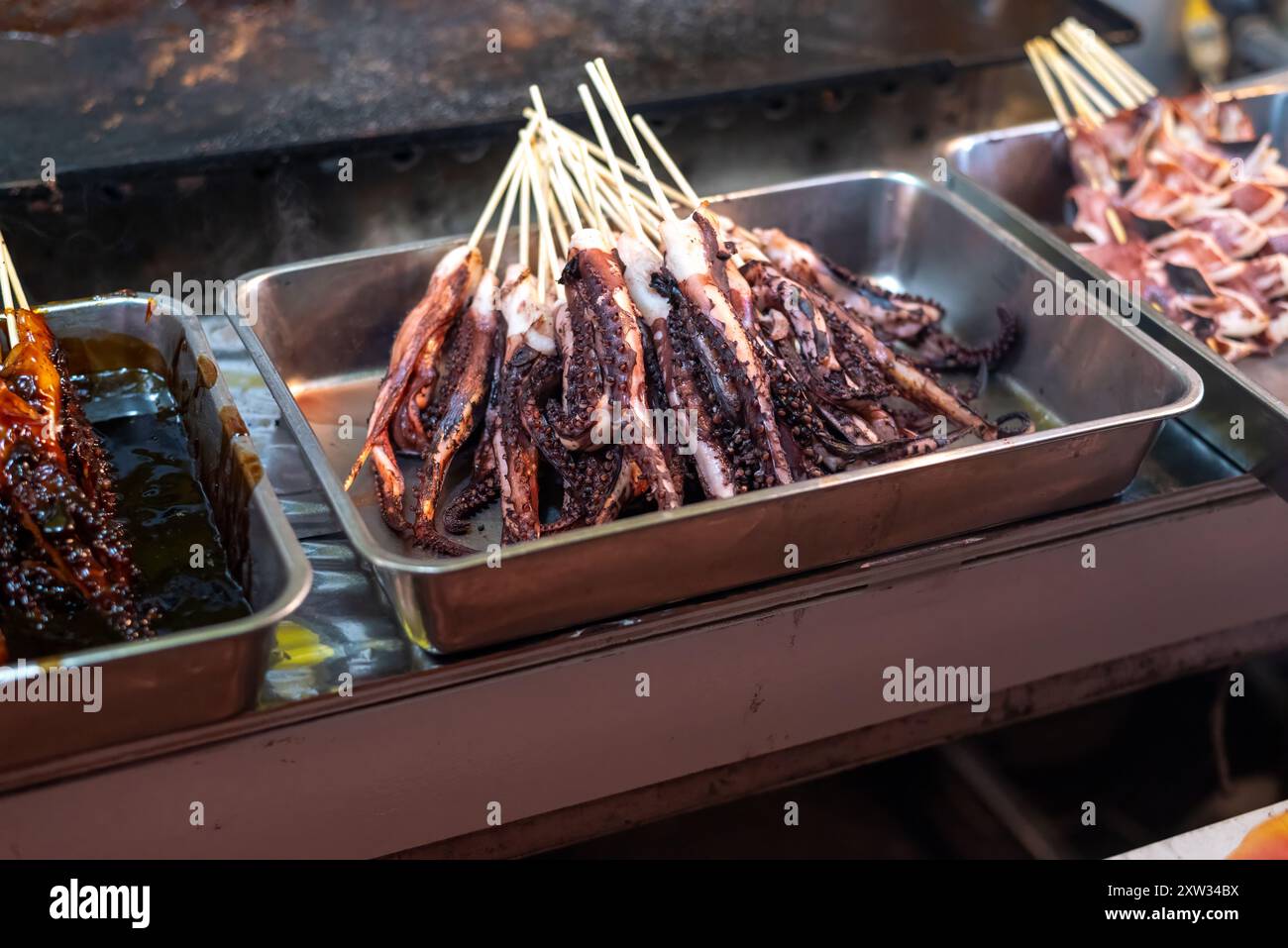 Squid tentacles on sticks known as ikayaki in Japan Stock Photo - Alamy