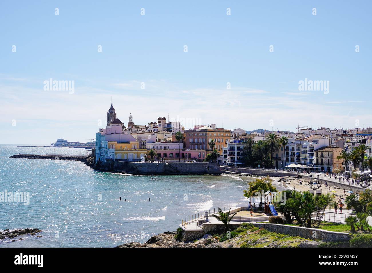 San Sebastián beach with Sant Bartomeu i Santa Tecla church in Sitges, Catalunya, Spain Stock Photo