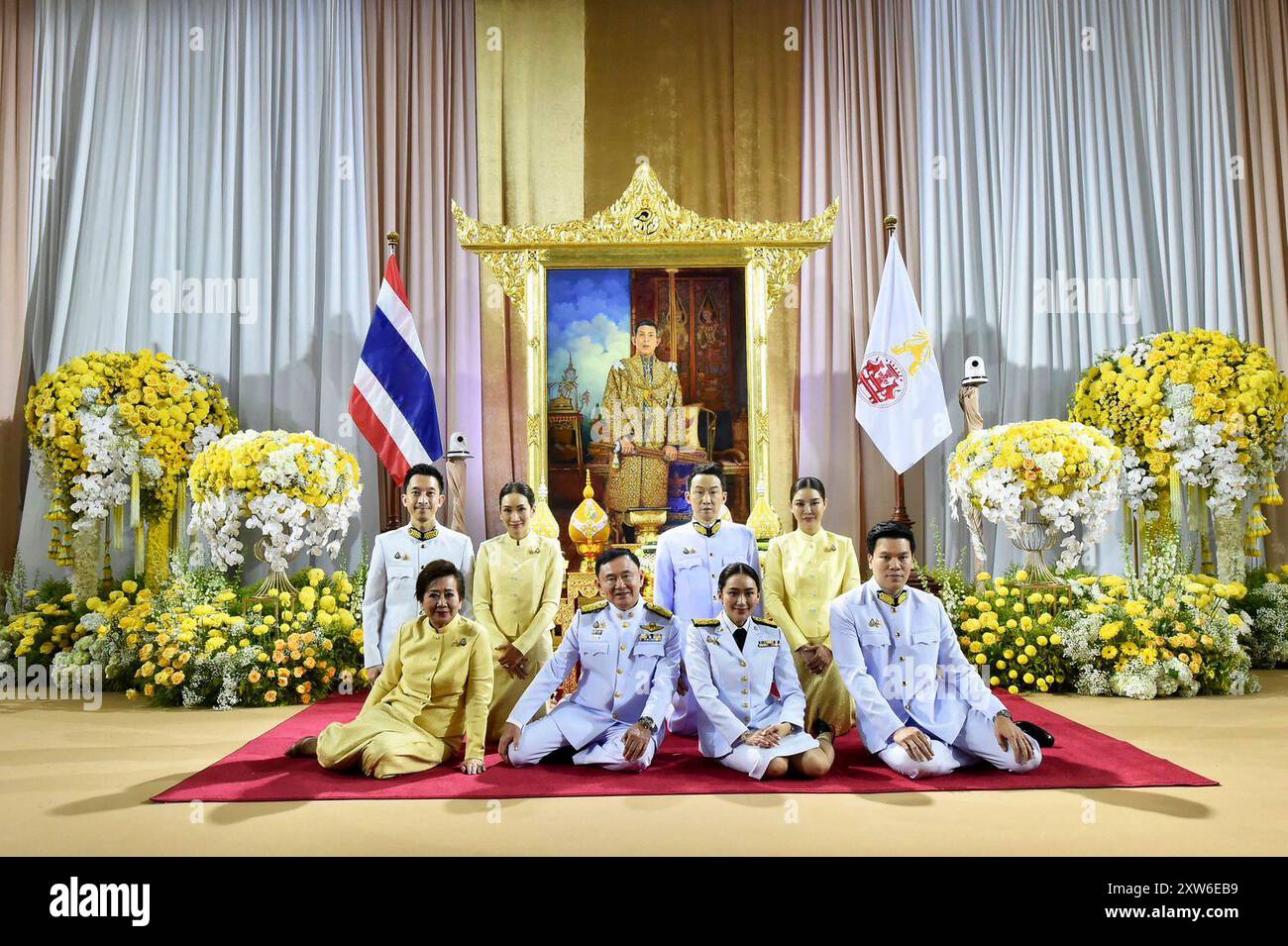 In this photo released by the Thai government spokesman office, Thailand's new prime minister Paetongtarn Shinawatra, front second right, and husband Pidok Sooksawas, front right, pose for a photo with her mother