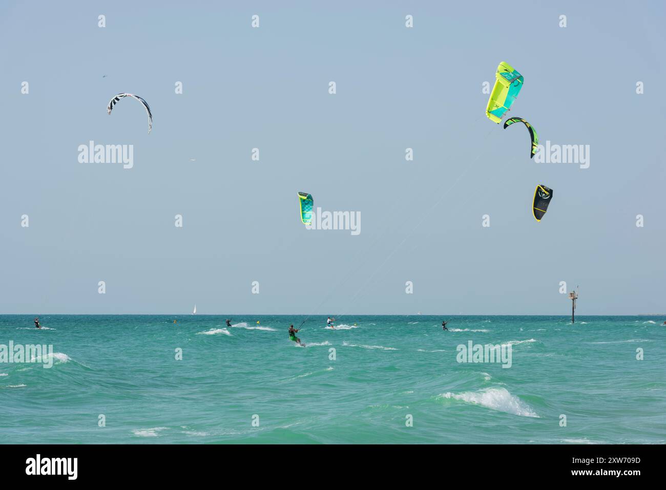 Dynamic scene of kitesurfers riding the waves Stock Photo - Alamy