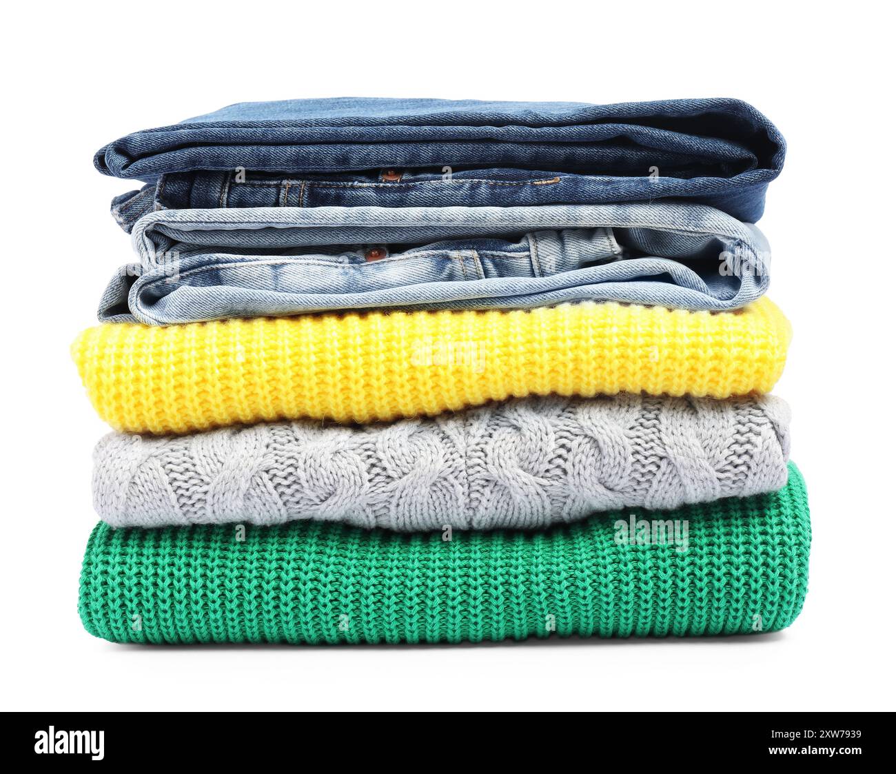 Stack of sweaters and jeans isolated on white Stock Photo