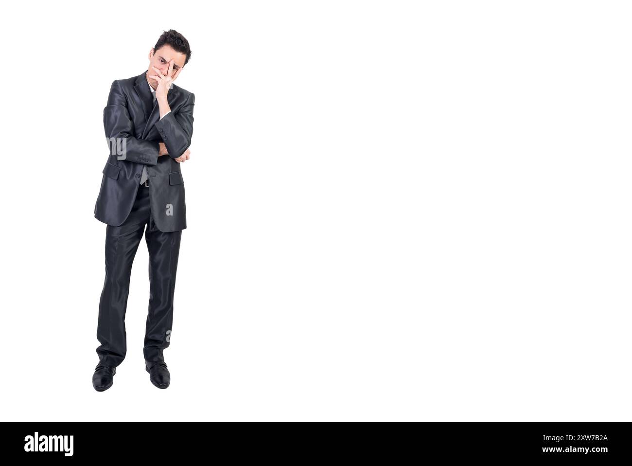 Thoughtful businessman doing facepalm gesture in studio Stock Photo