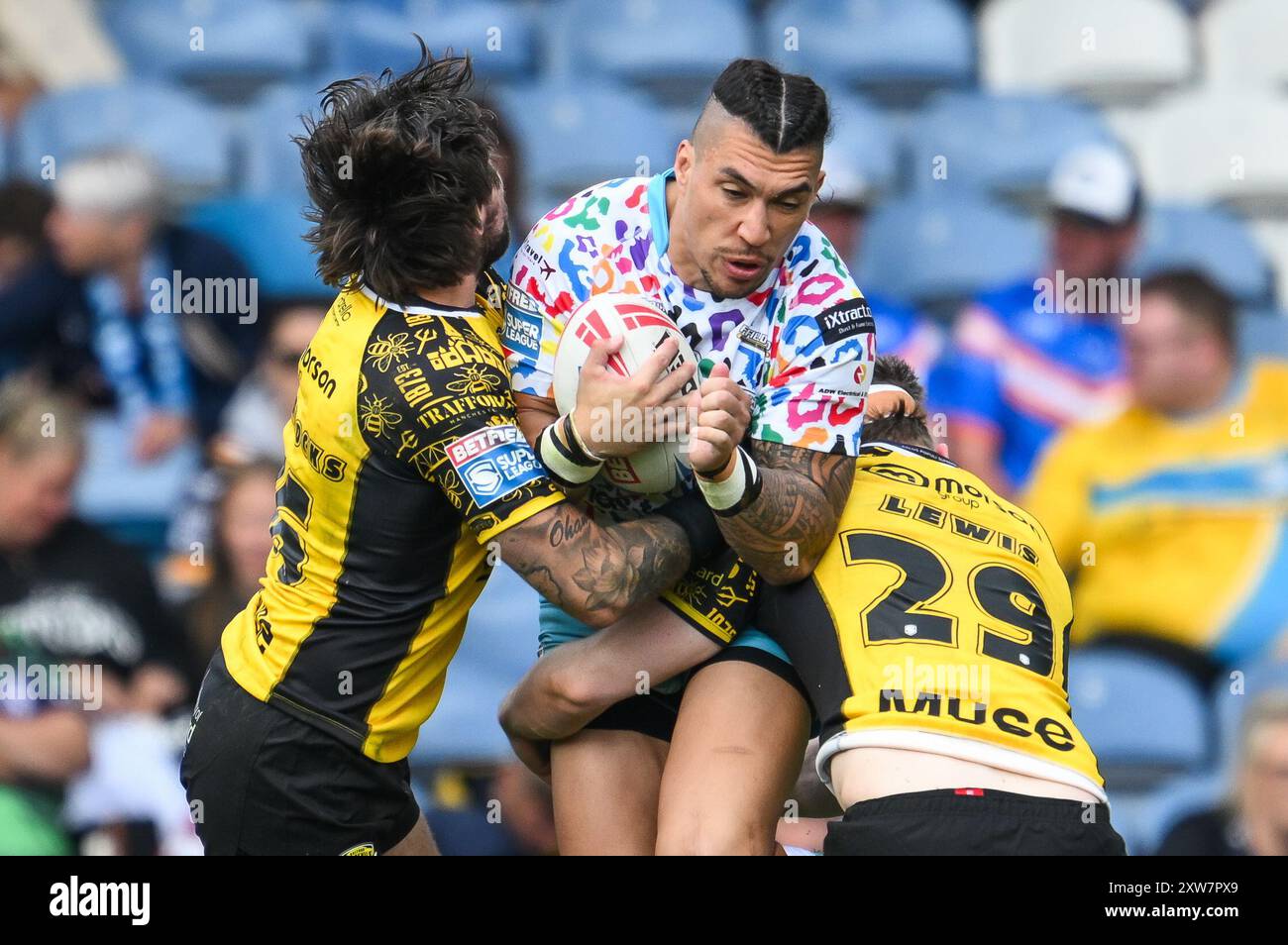 Aaron Pene of Leigh Leopards is tackled by Joe Shorrocks of Salford Red Devils and Loghan Lewis of Salford Red Devils during the Magic Weekend match Leigh Leopards vs Salford Red Devils at Elland Road, Leeds, United Kingdom, 18th August 2024 (Photo by Craig Thomas/News Images) in, on 8/18/2024. (Photo by Craig Thomas/News Images/Sipa USA) Credit: Sipa USA/Alamy Live News Stock Photo