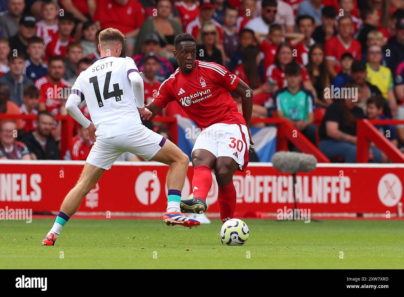 Willy Boly of Nottingham Forest gets the ball away from Alex Scott of Bournemouth during the Nottingham Forest FC v Bournemouth FC English Premier League match at the City Ground, Nottingham, England, United Kingdom on 17 August 2024 Stock Photo