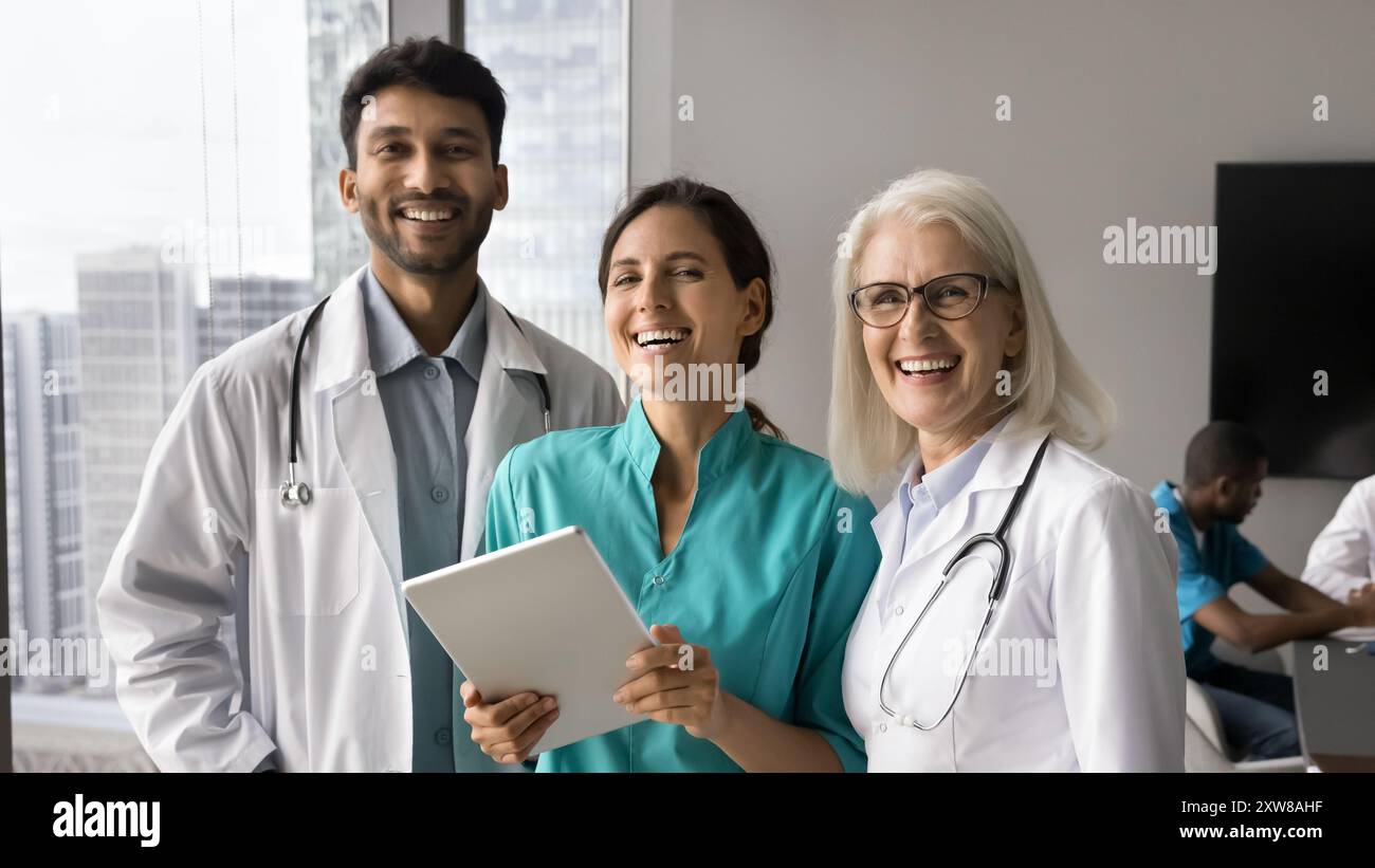 Three multiracial internists team mates looking at camera Stock Photo
