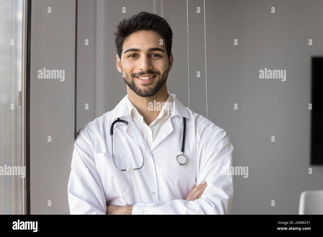 Arabian male doctor posing smiling confidently at camera Stock Photo ...