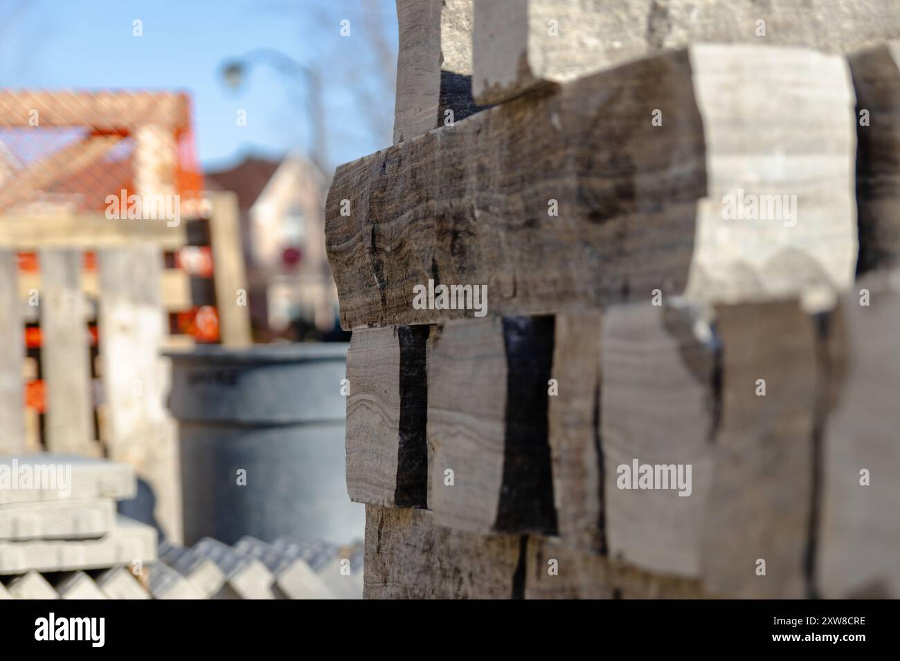 Close-up of stacked bricks with blurred urban background. Taken in Toronto, Canada. - Stock Image