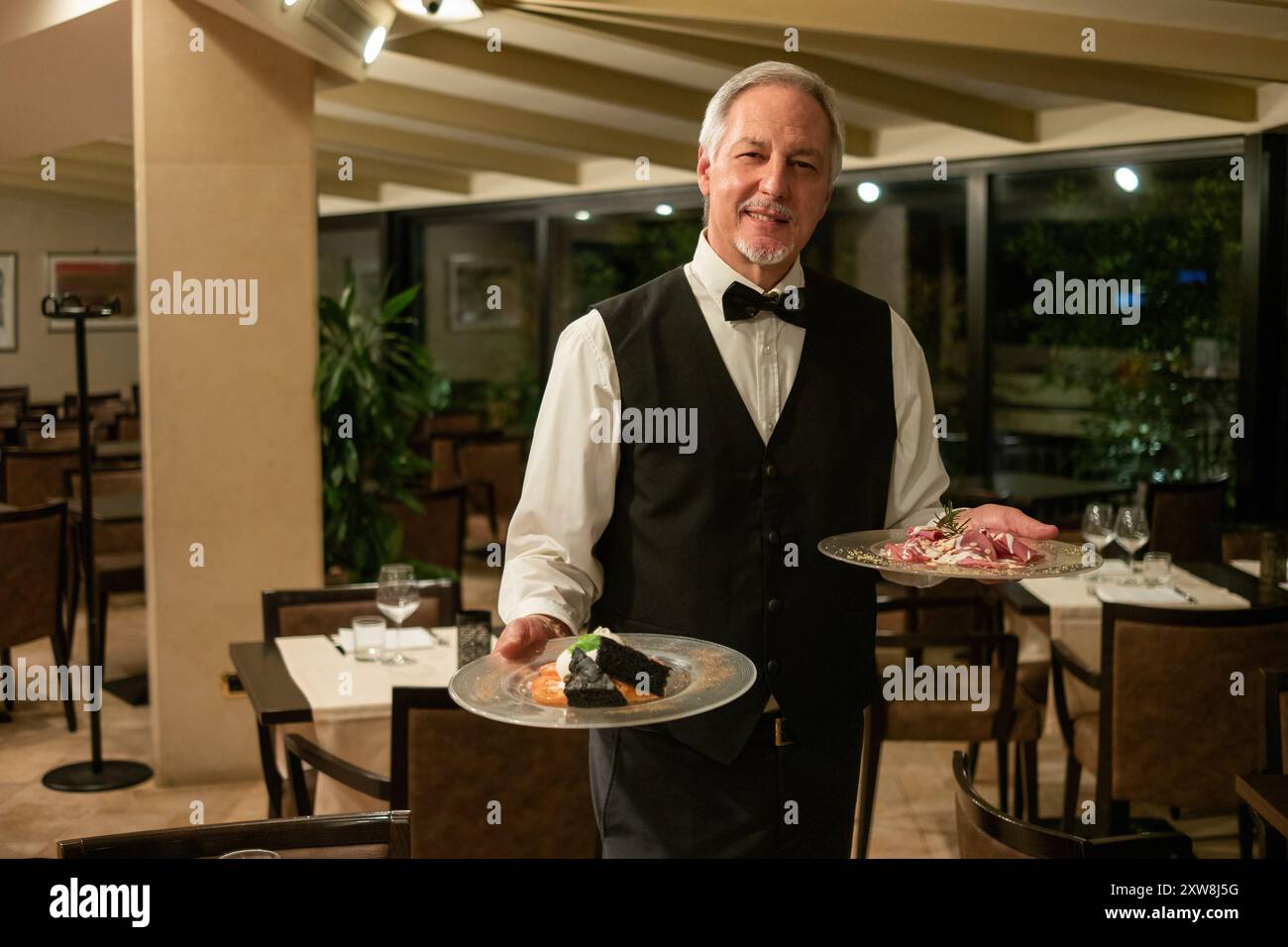 Handsome waiter serving tray hi-res stock photography and images - Alamy