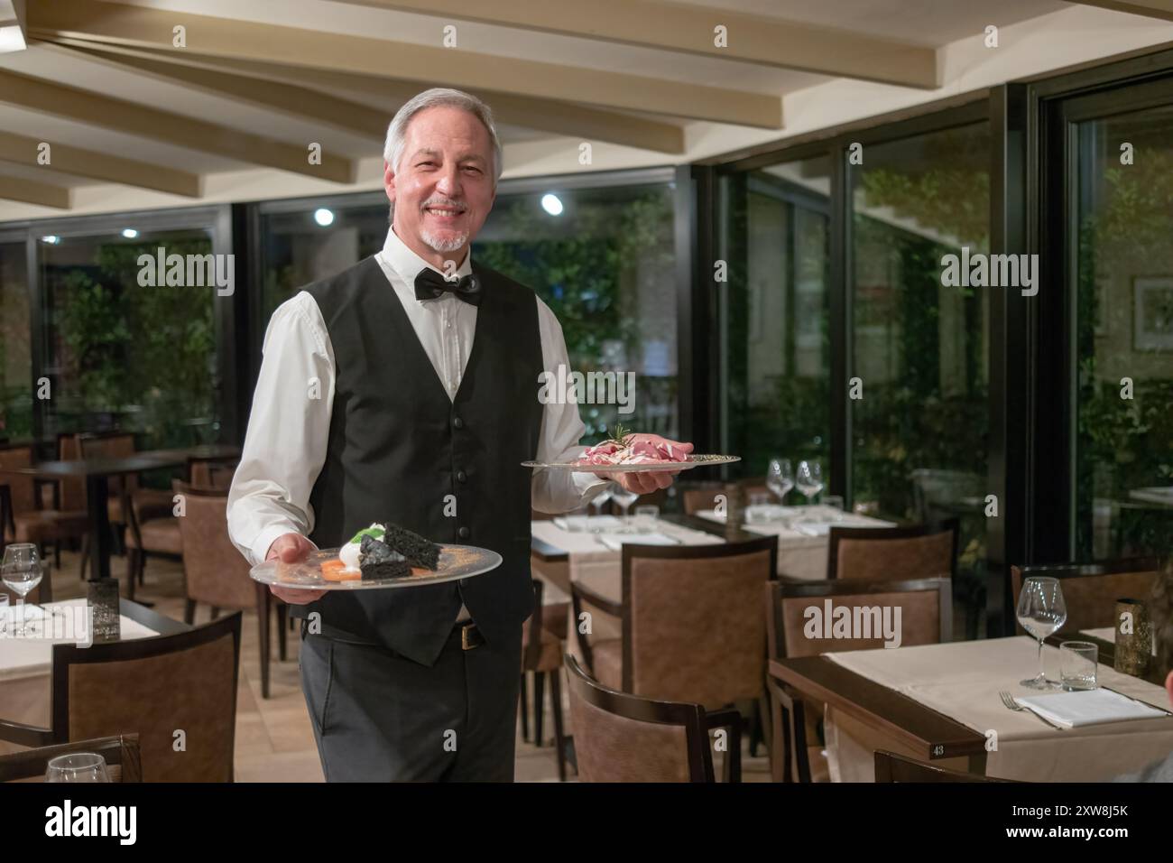 Waiter in black white uniform hi-res stock photography and images - Alamy