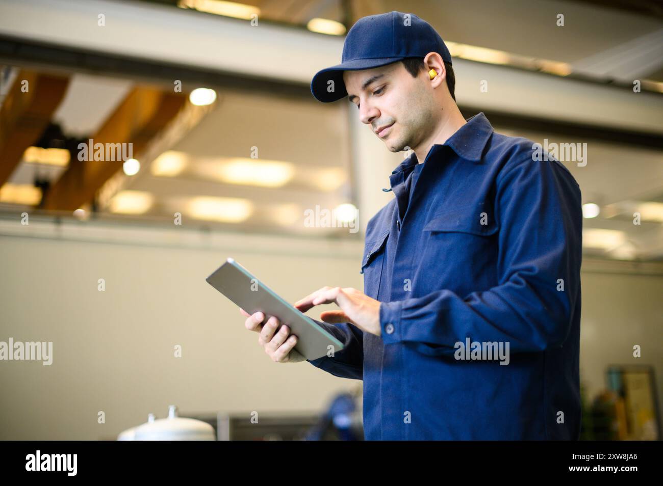 Portrait af an engineer using a tablet in a facility Stock Photo