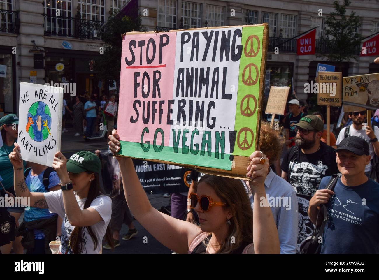 London, UK. 17th August 2024. Animal rights activists pass through ...