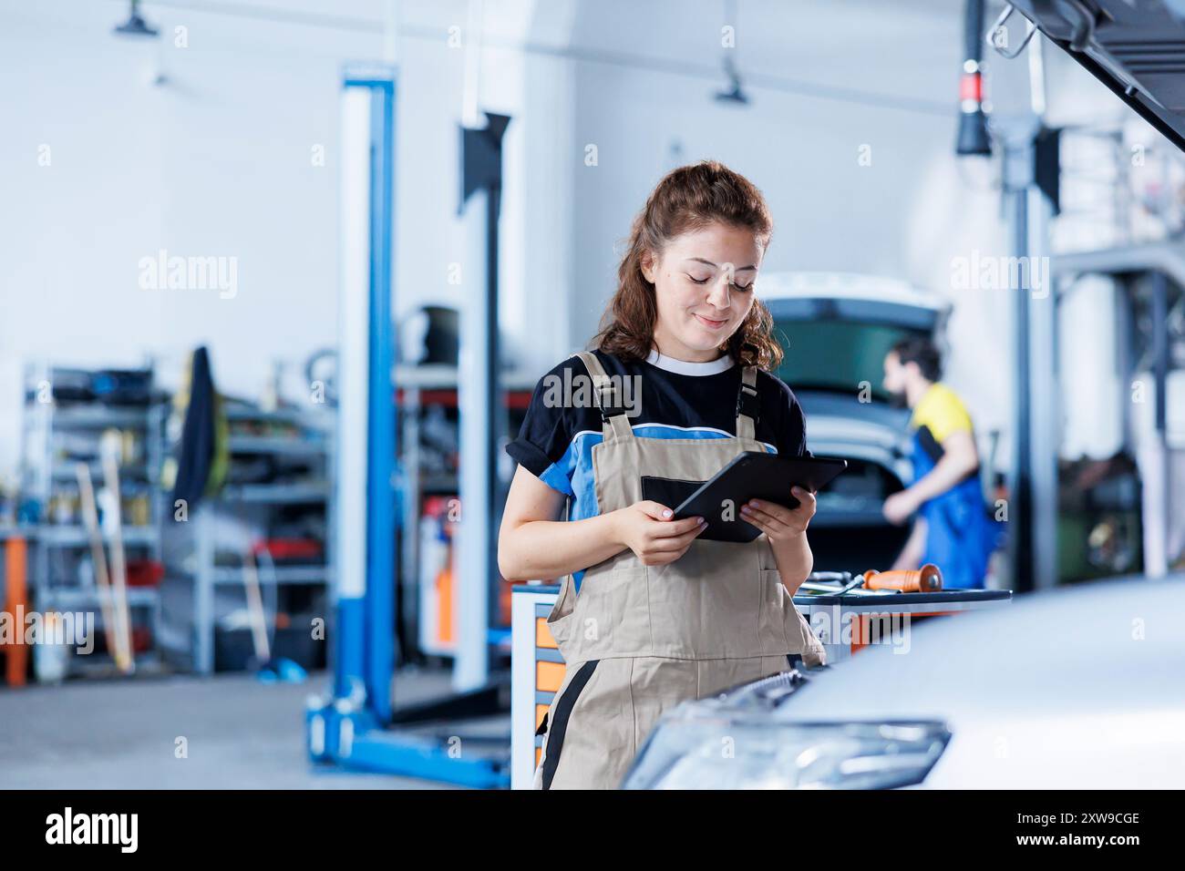 Photo inspiration: Picture Idea: Technician In Car Service Uses Tablet To Calculate Invoice For