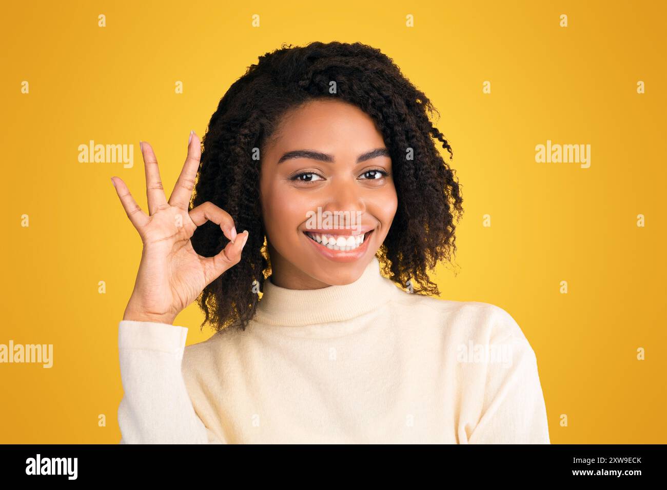 Happy african american girl showing ok sign gesture Stock Photo - Alamy