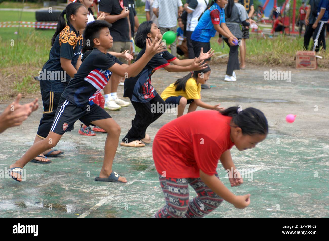 Water balloon catching game, during a community event at Bongkud, Ranau ...