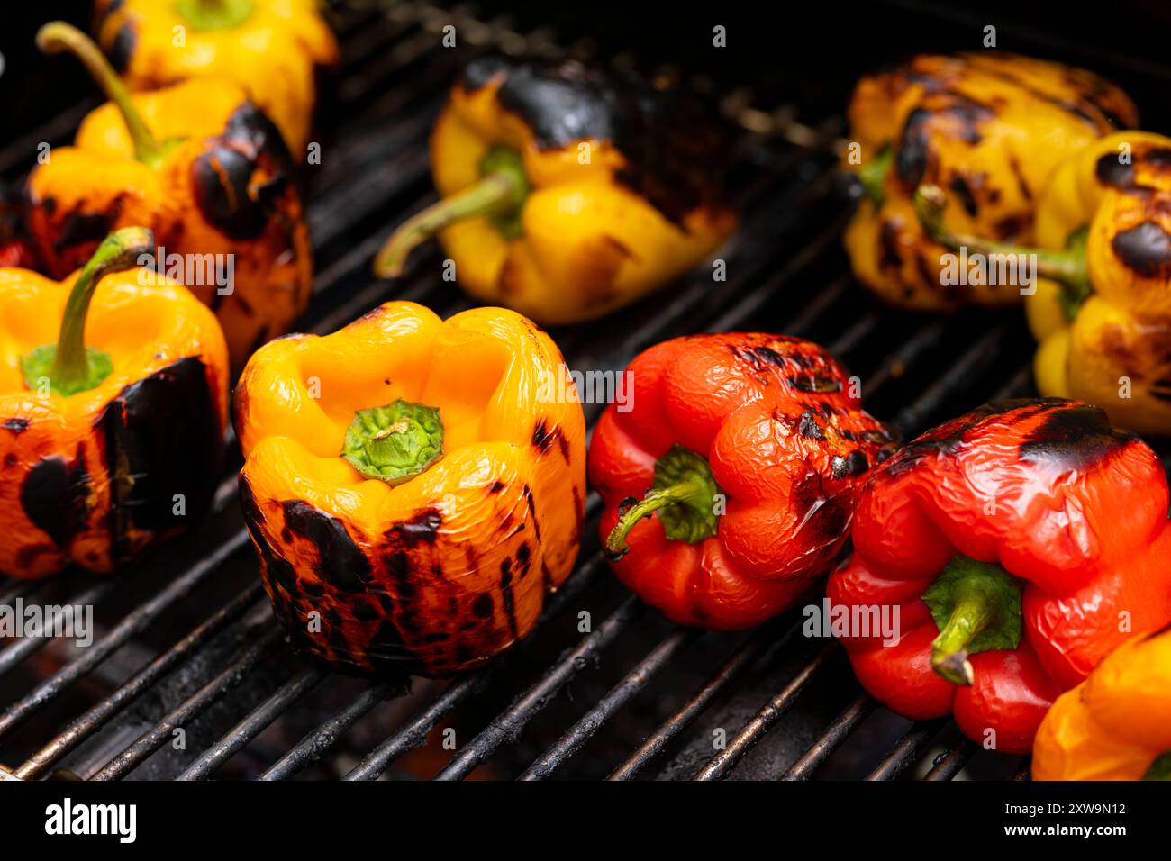 Red and yellow grilled pepper on BBQ fireplace Stock Photo - Alamy