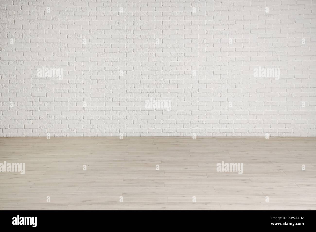 View of empty room with white brick wall and laminate floor Stock Photo ...