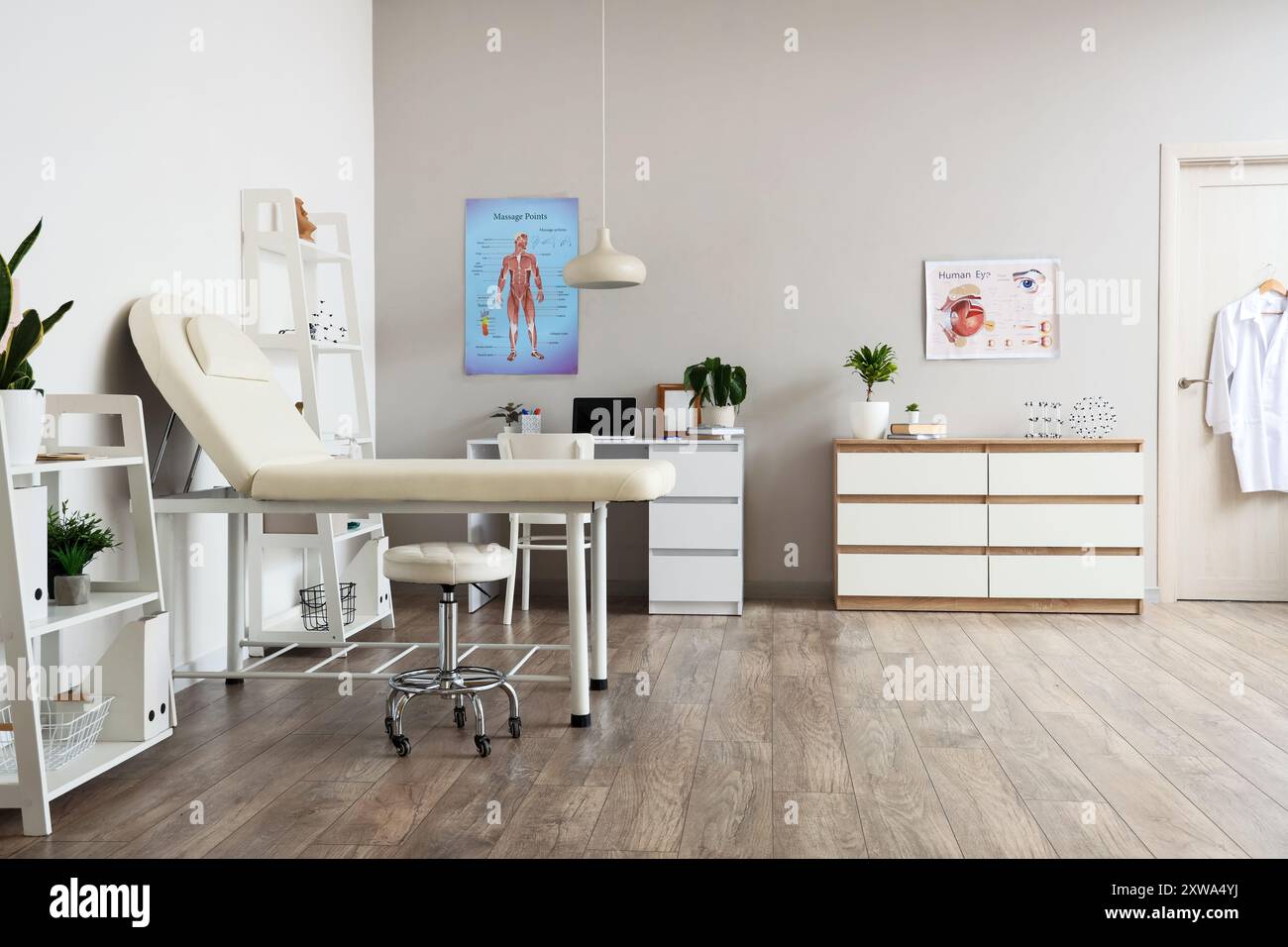 Interior of medical office with couch, shelf units and doctor's ...