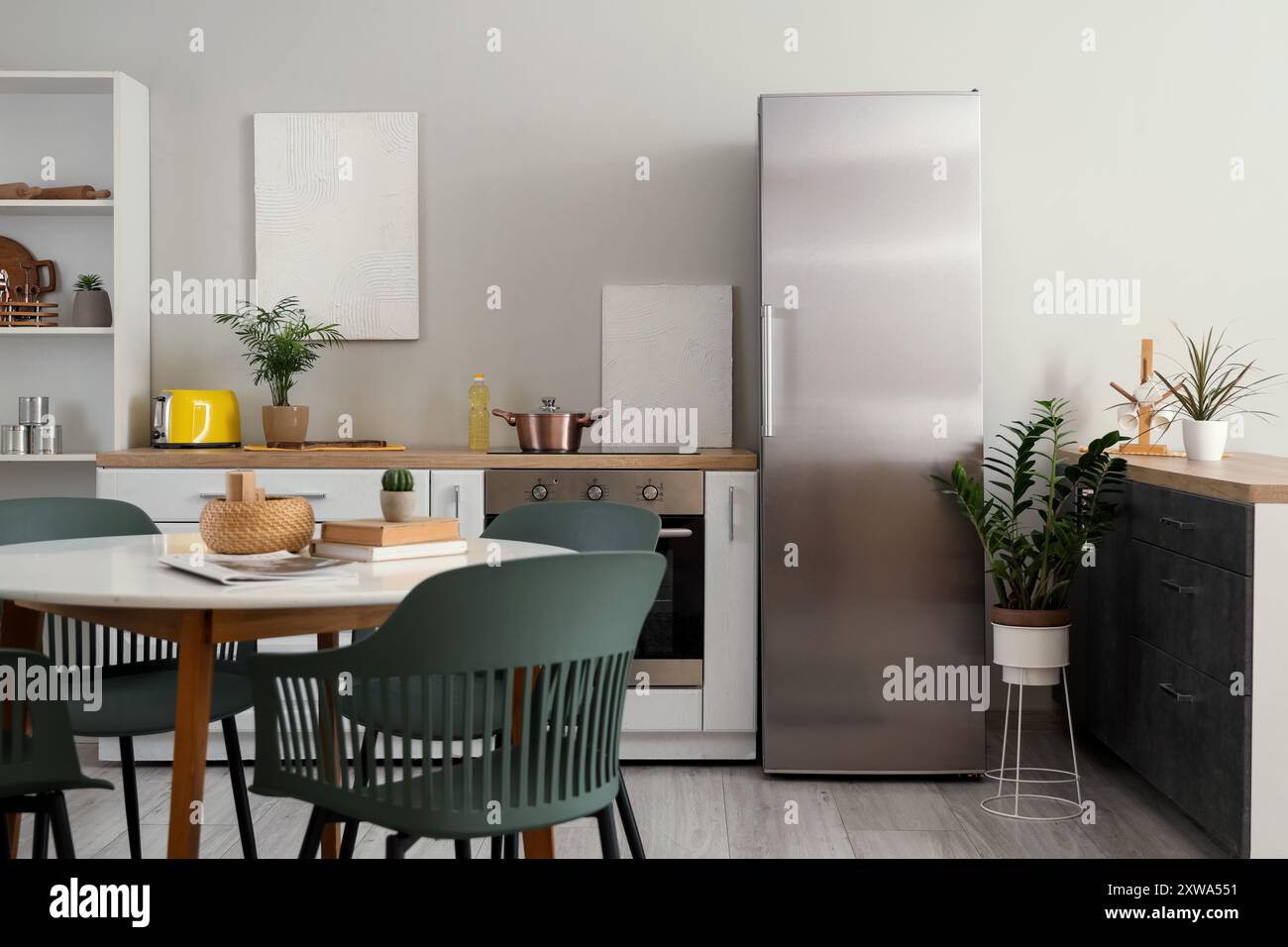 Stylish interior of modern kitchen with fridge, counter and dining ...