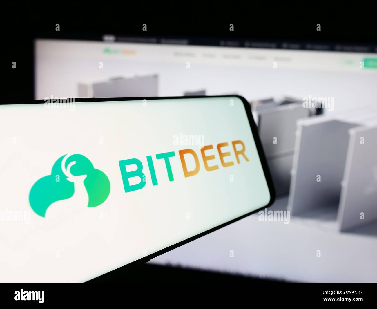 Mobile phone with logo of Singaporean blockchain company Bitdeer  Technologies Group in front of website. Focus on center-left of phone  display Stock Photo - Alamy