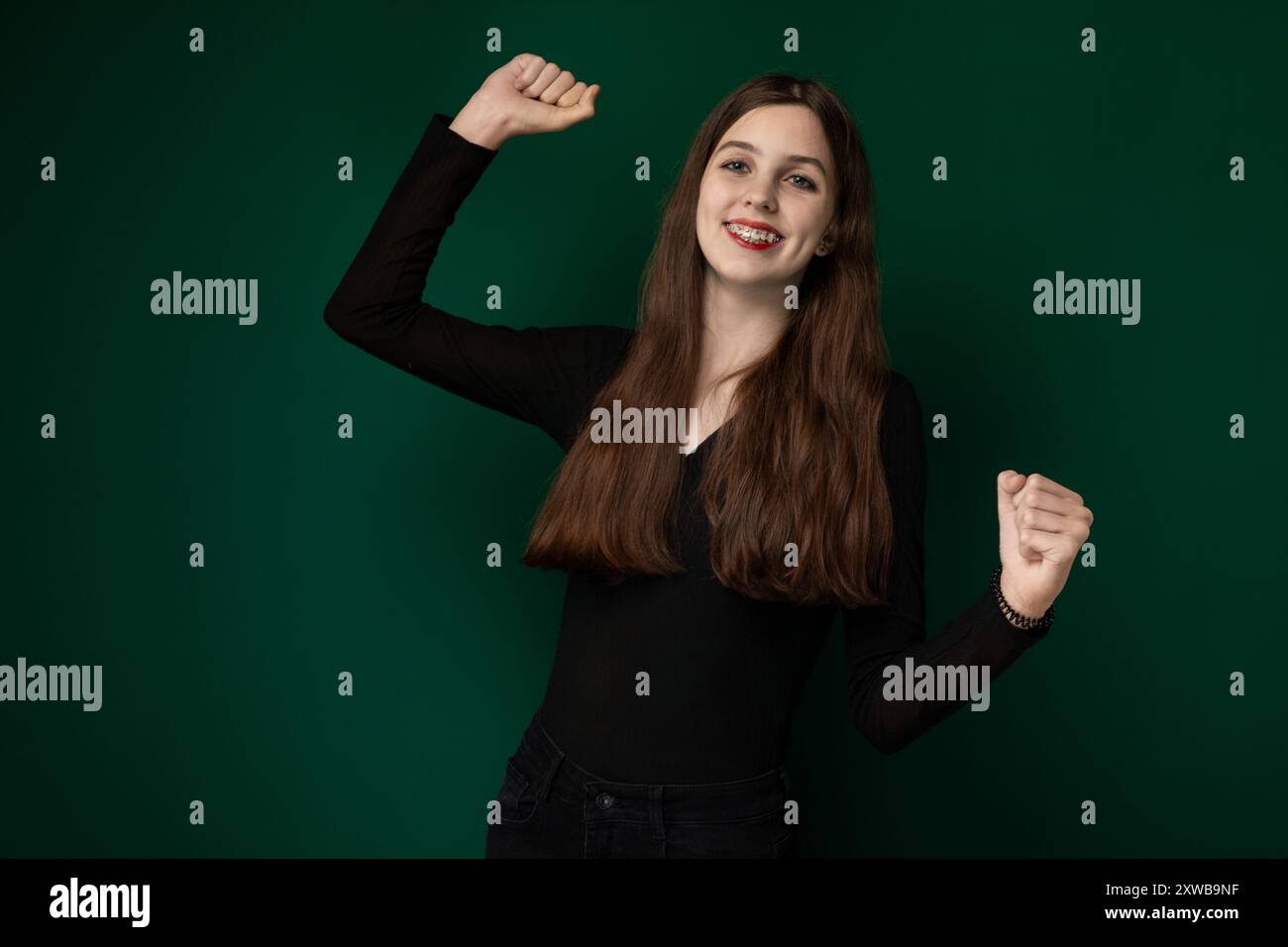 Woman Posing With Arms Raised Stock Photo - Alamy