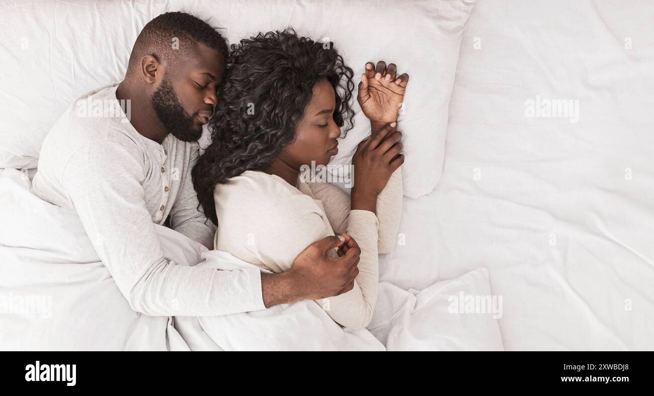 Married african couple sleeping in bed and cuddling, top view Stock ...