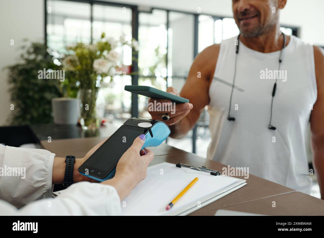 Man Using Mobile Phone To Pay For Sport Training Stock Photo