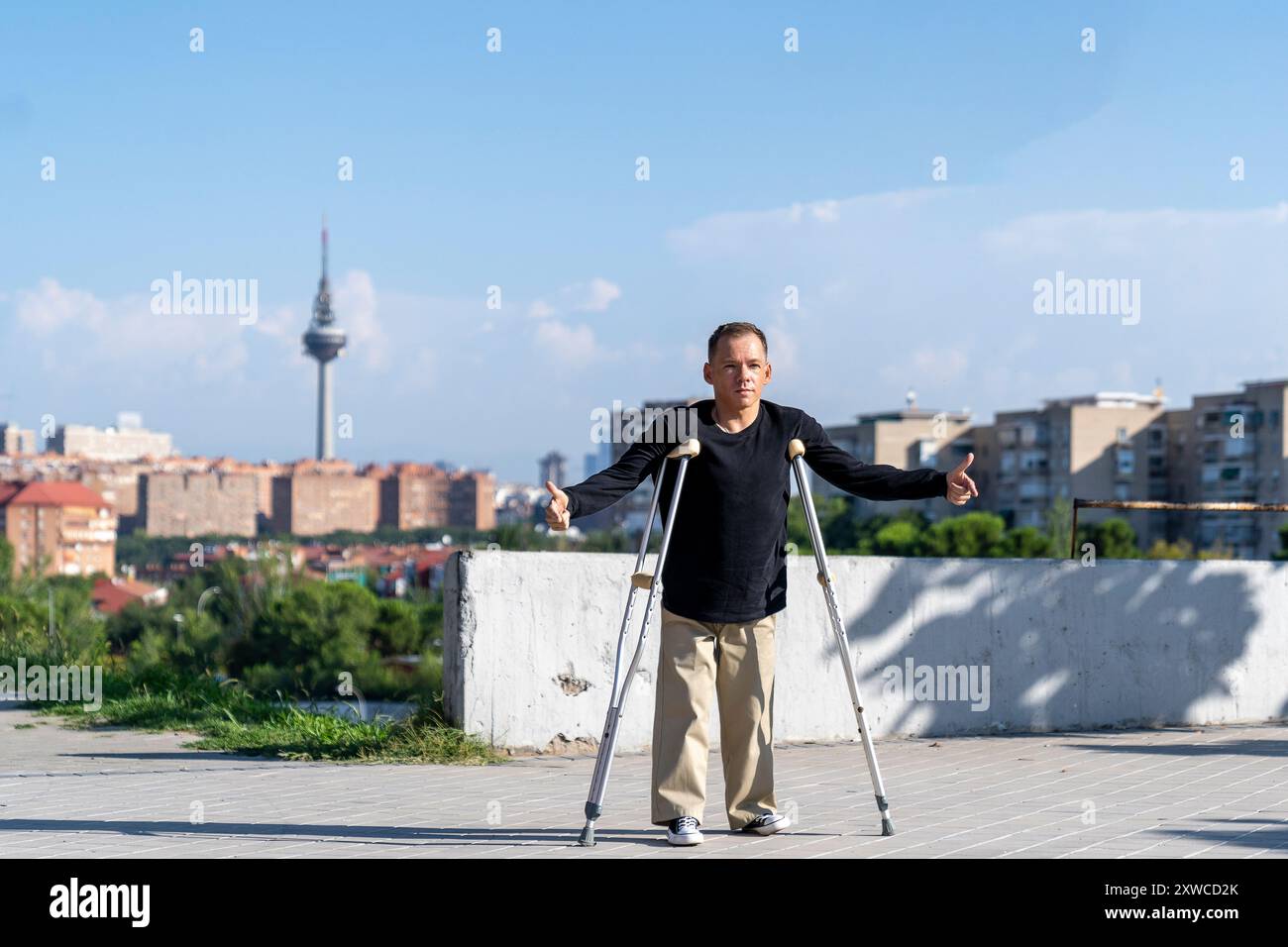 disabled man posing for a photograph with his crutches Stock Photo