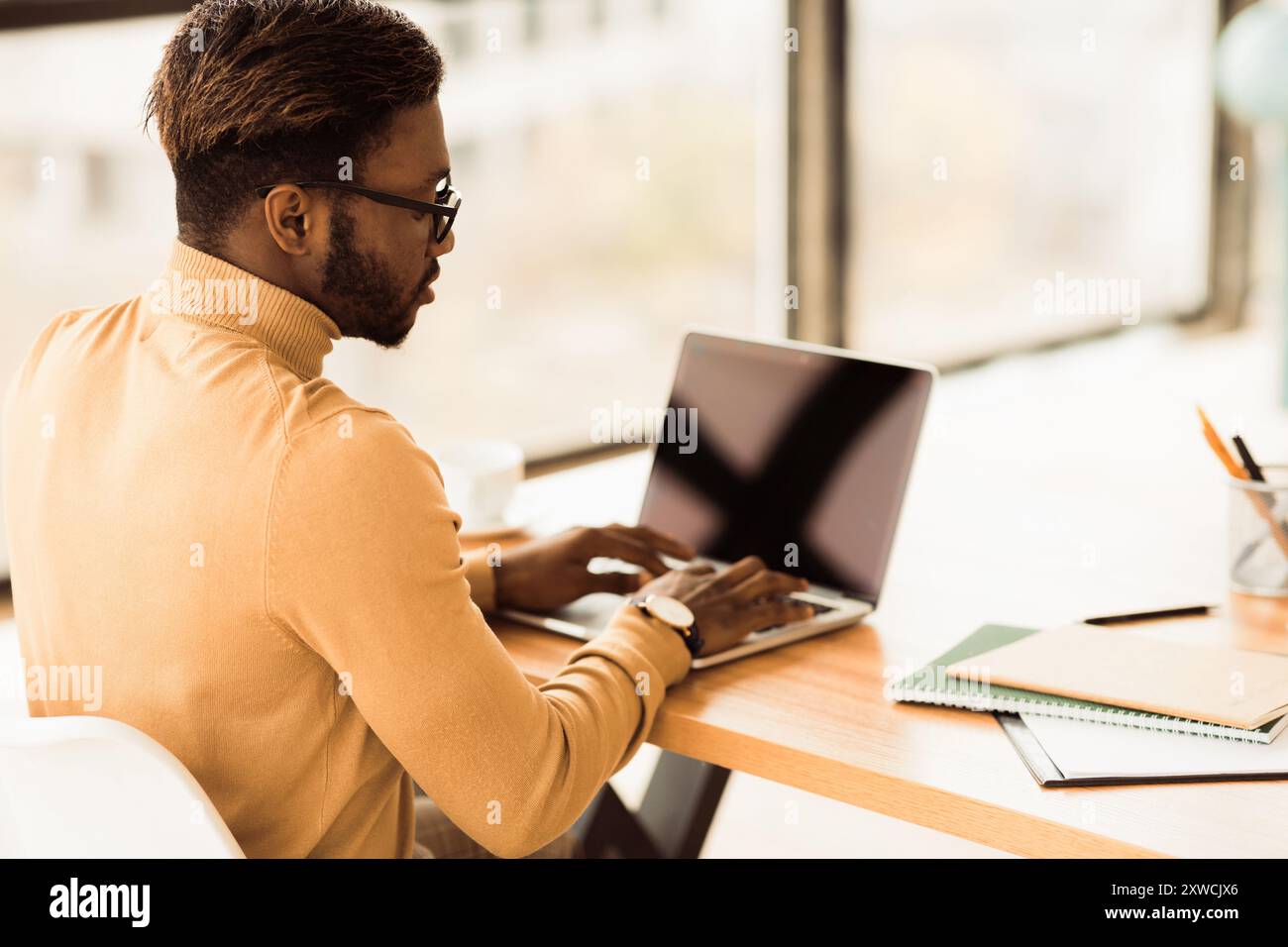 Focused black guy checking email on computer Stock Photo