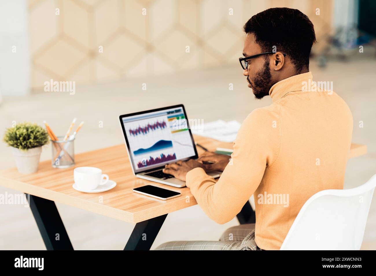 Black manager working with diagrams on pc Stock Photo