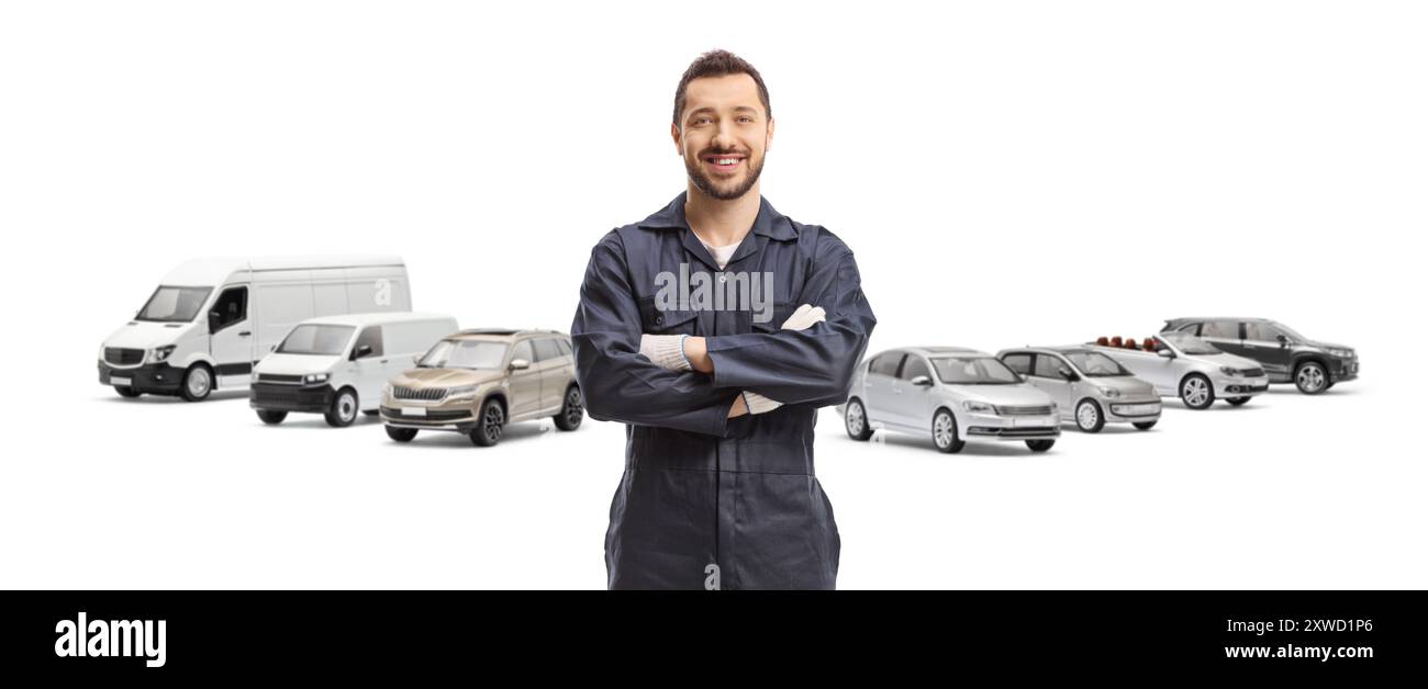 Mechanic posing in front of parked vehicles isolated on white background Stock Photo