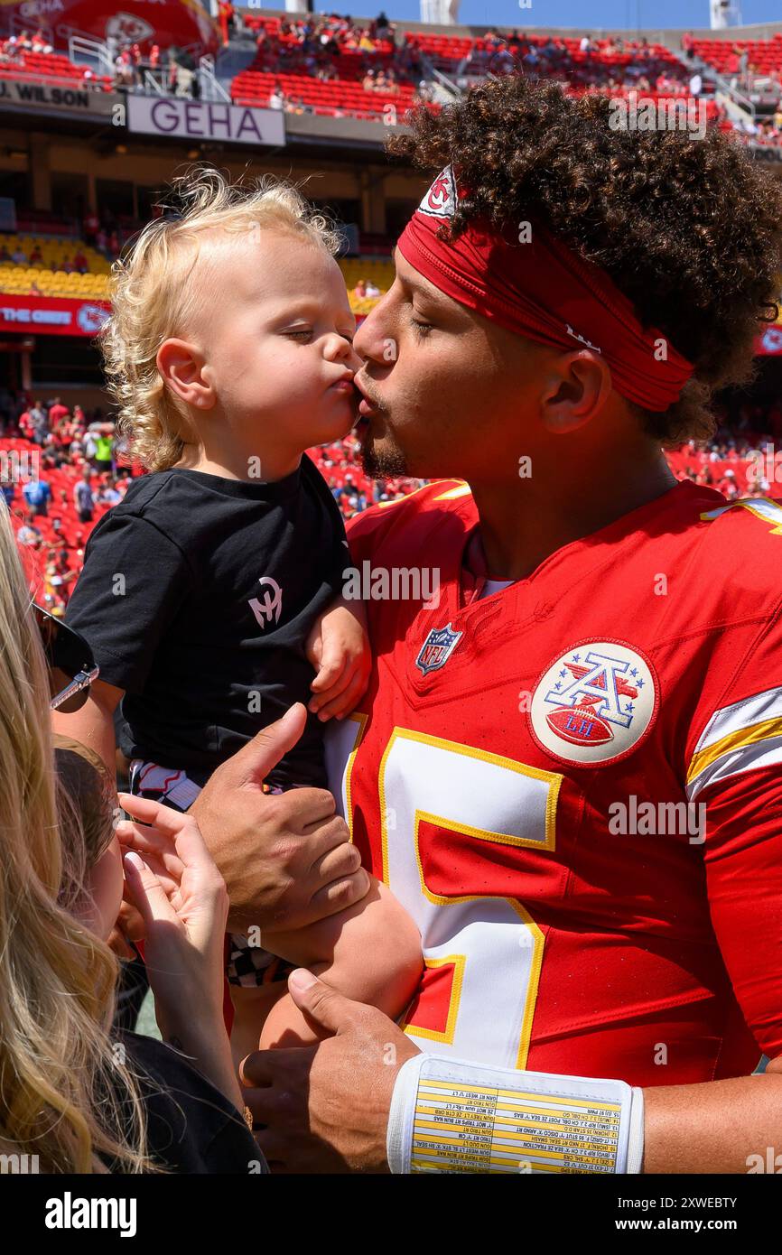 Kansas City Chiefs quarterback Patrick Mahomes gives his son Bronze a kiss  after warmups before an NFL football game against the Detroit Lions,  Saturday, Aug. 17, 2024 in Kansas City, Mo. (AP