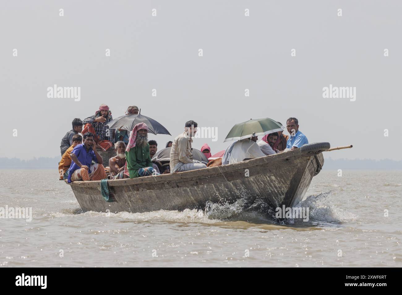 People onboard one of the river boats moving between the different chars in the Brahmaputra river. Stock Photo