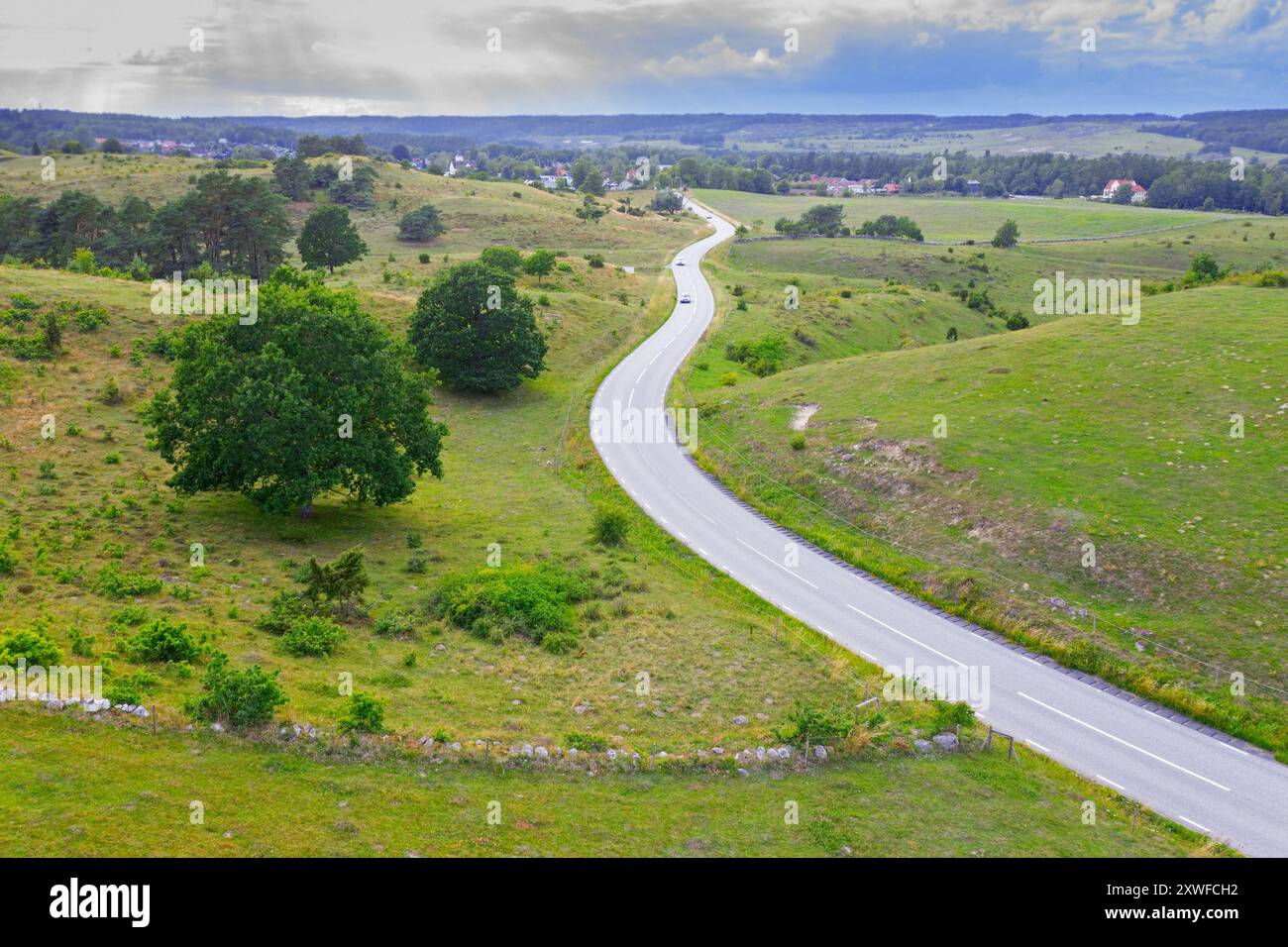 Aerial view of winding road curves through the hills of Brösarps backar / Brösarp's slopes in summer, Skåne län, Skane / Scania, Sweden Stock Photo