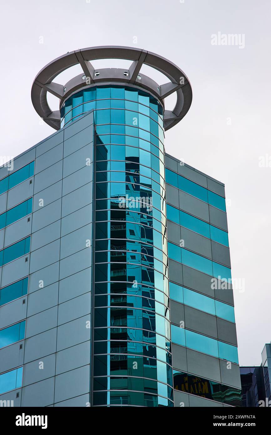Modern Glass Office Tower with Reflective Windows Low-Angle View Stock Photo