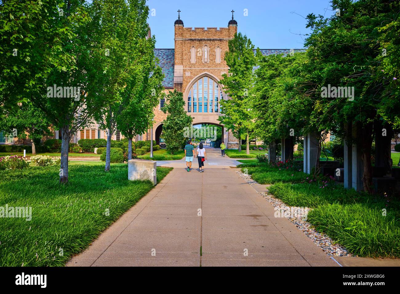 Gothic Campus Walkway with Twin Towers on a Sunny Day Perspective Stock Photo