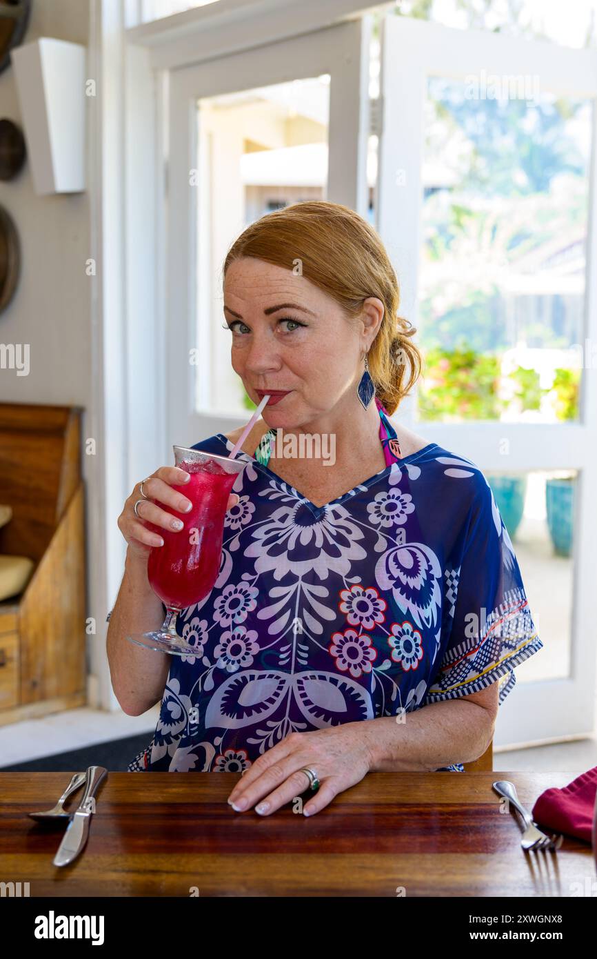 Woman Enjoying Cocktail, Belize Stock Photo