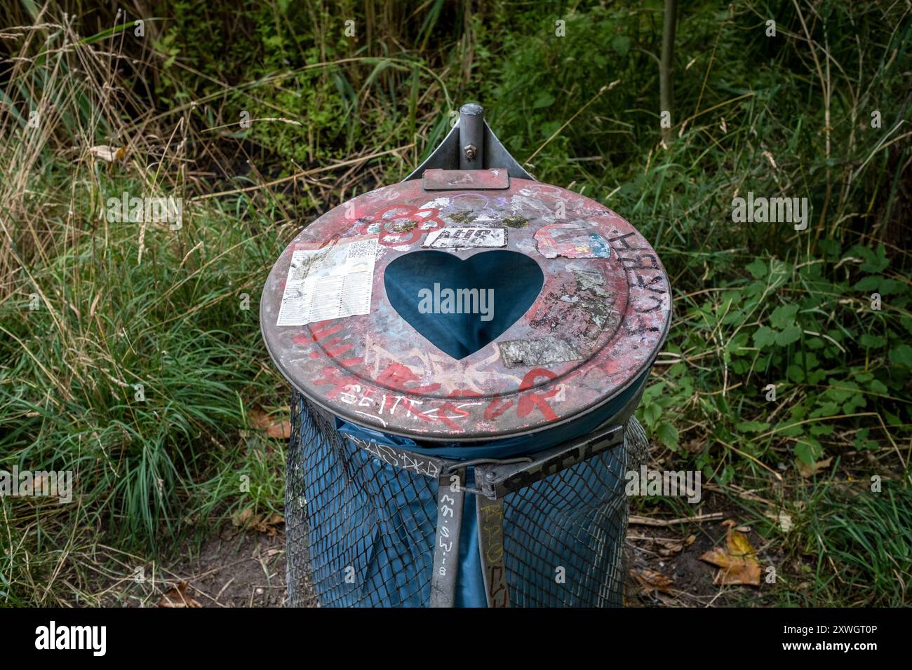 Heart shape cut into a trash can in Copenhagen's Freetown Christiania neighborhood Stock Photo