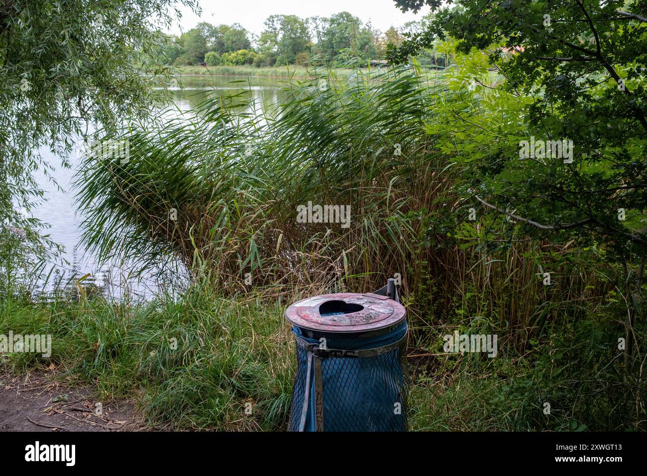 Heart shape cut into a trash can in Copenhagen's Freetown Christiania neighborhood Stock Photo