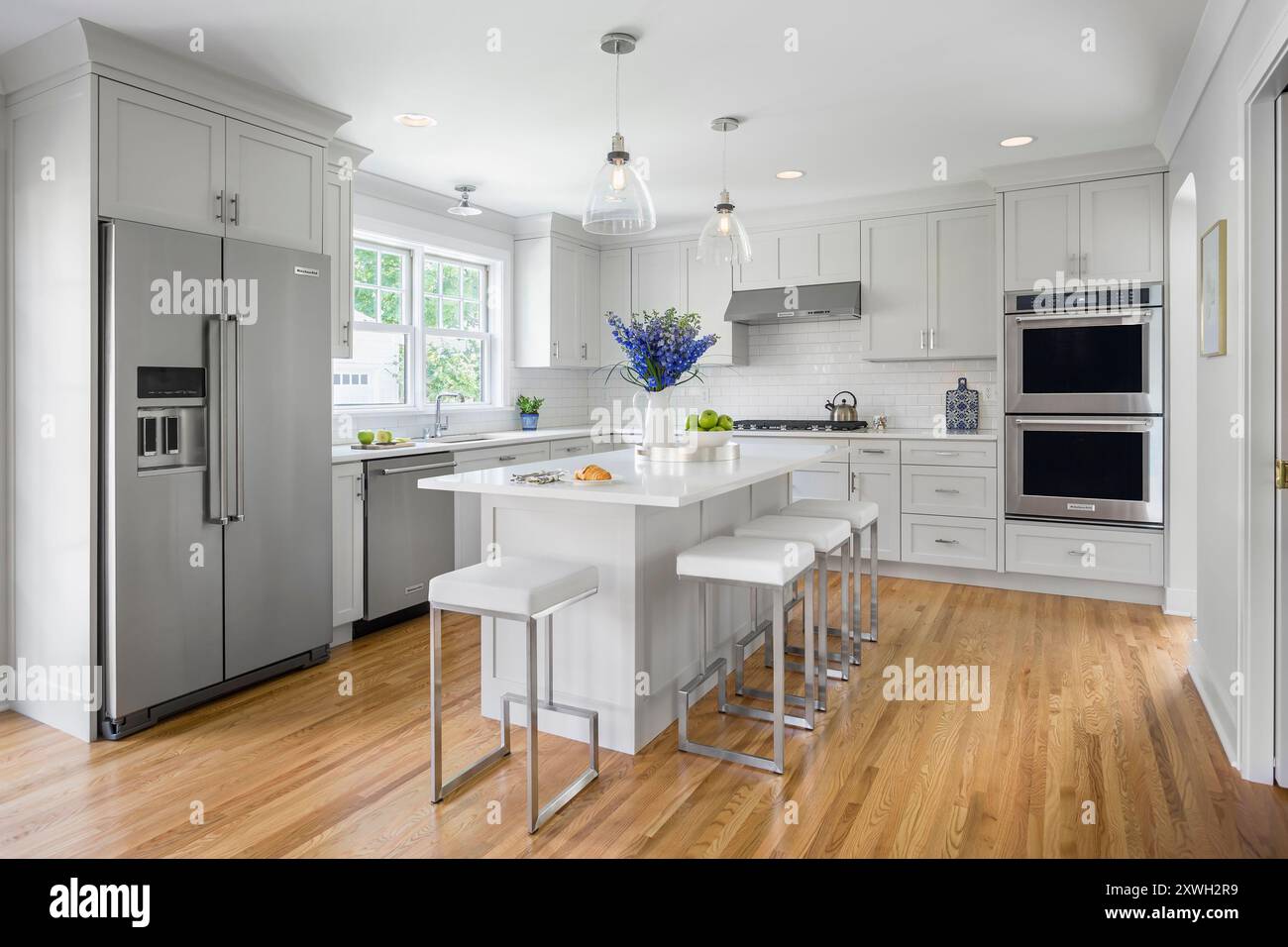 Kitchen with center island in soft shades of white and gray Stock Photo ...
