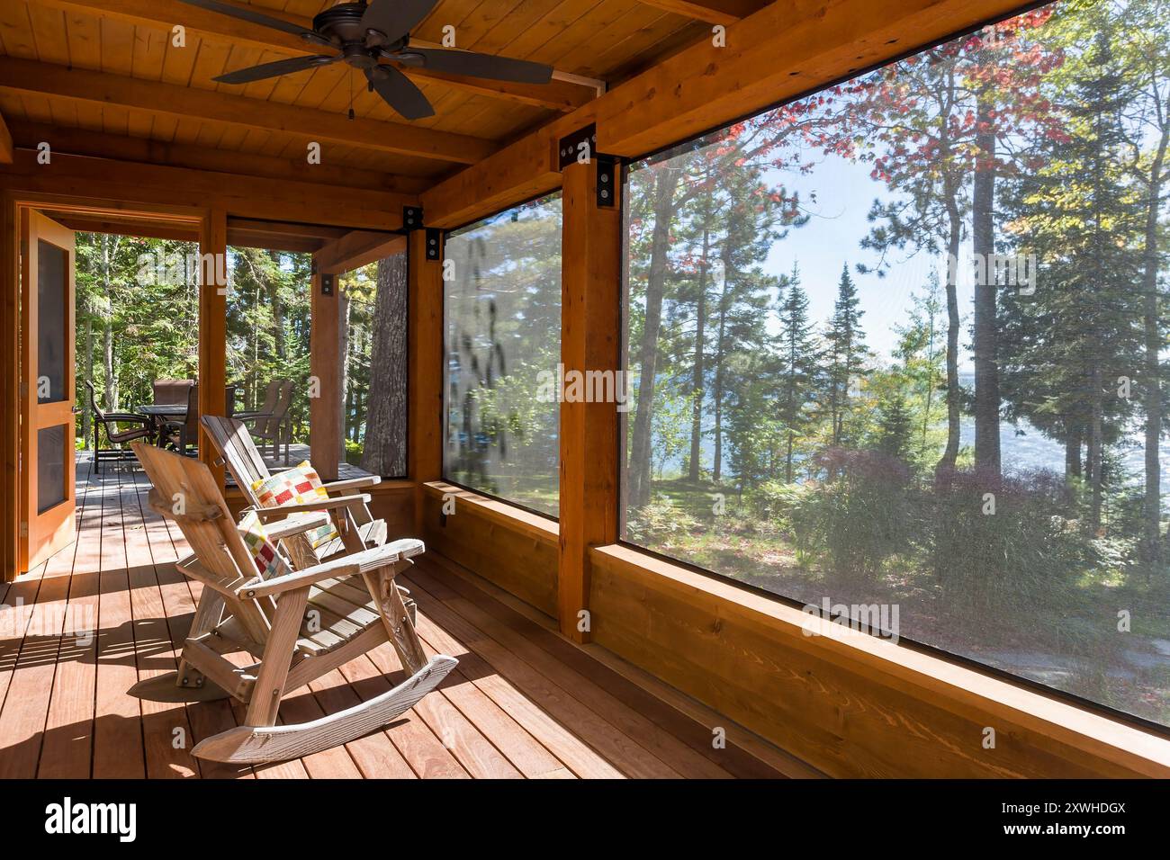 Interior of northwoods cabin screened porch looking out to trees and ...