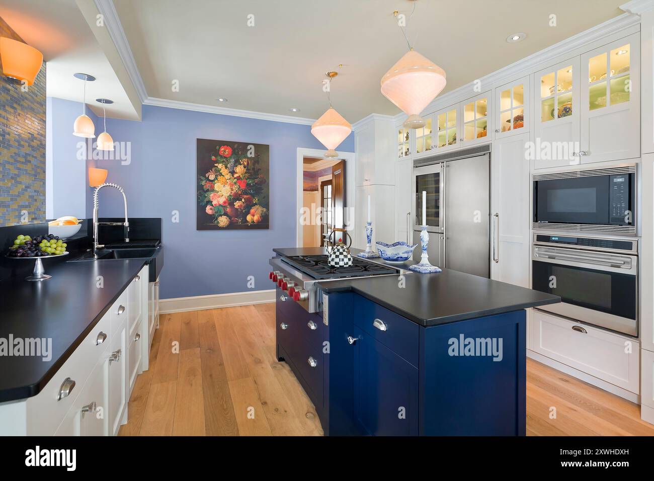 Beautiful kitchen with white cabinets, blue walls and black countertops  Stock Photo - Alamy, image size:1300x956