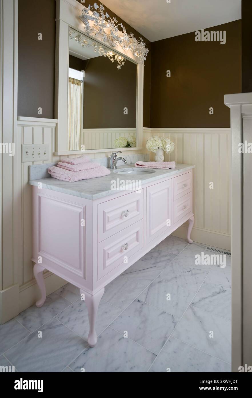 Feminine bathroom with pink vanity and white wainscotting Stock Photo ...