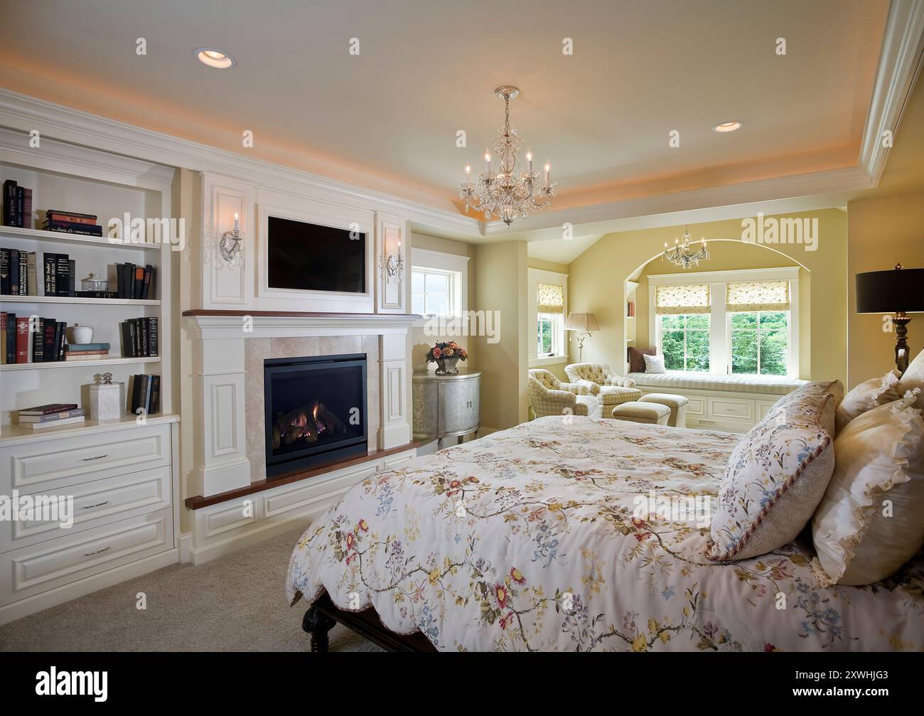 Master bedroom suite with sitting area and television over fireplace ...