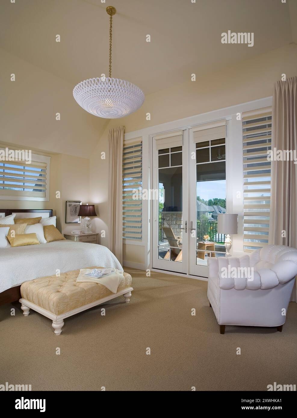 Bedroom with double doors leading to large outdoor deck Stock Photo - Alamy