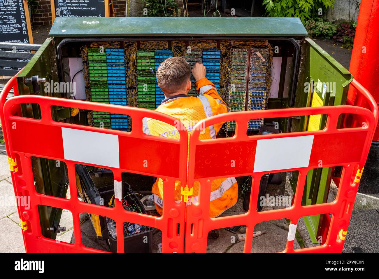 A Broadband Engineer Working In The High Street, Lewes, Sussex, UK. Stock Photo